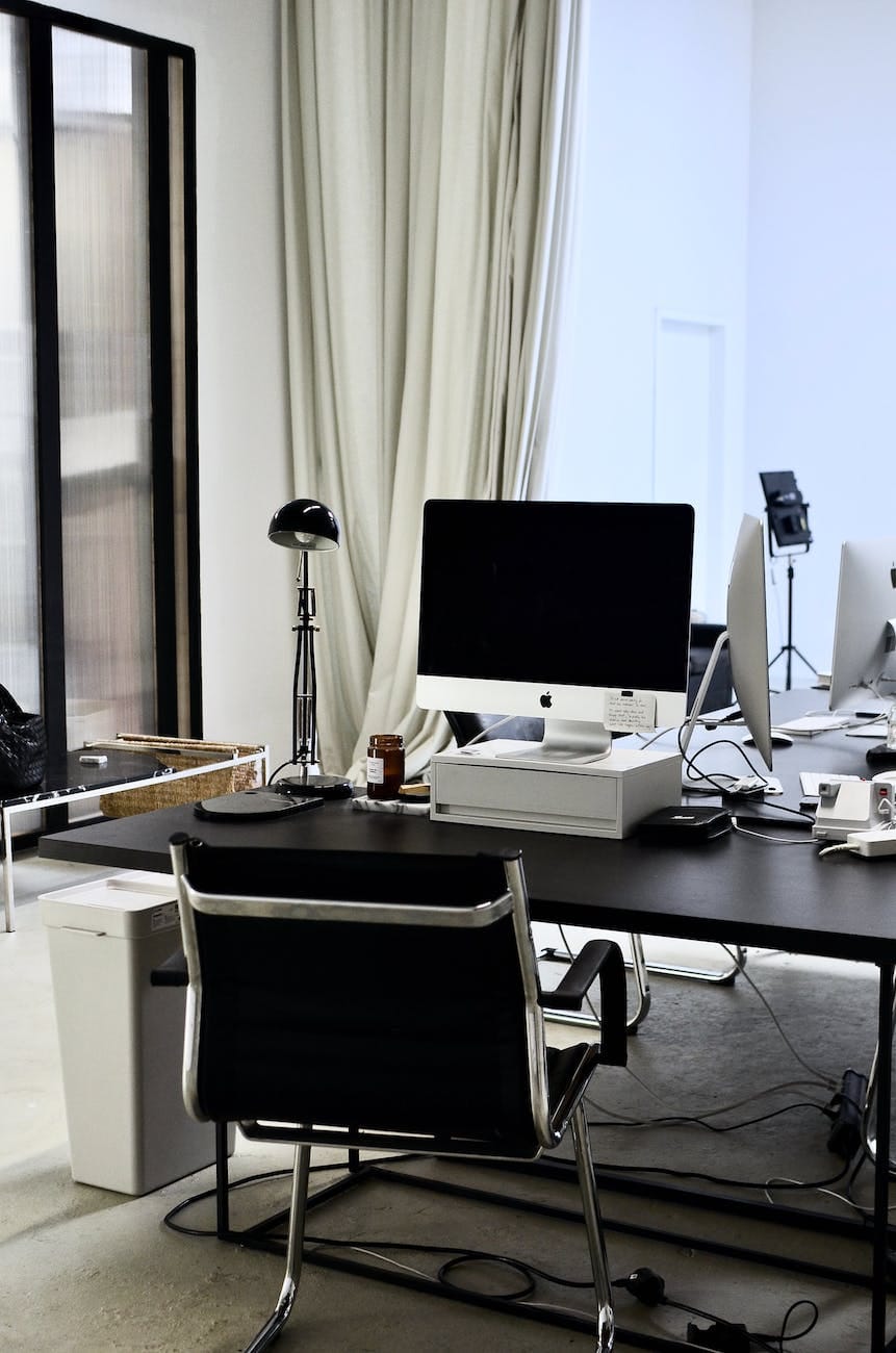 Public Company in India 3 contemporary workspace with computer on table and chair in office